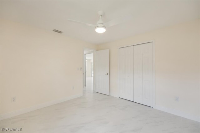 2232 Longboat Dr, Naples, FL 34104 - unfurnished bedroom featuring baseboards, a closet, and a ceiling fan