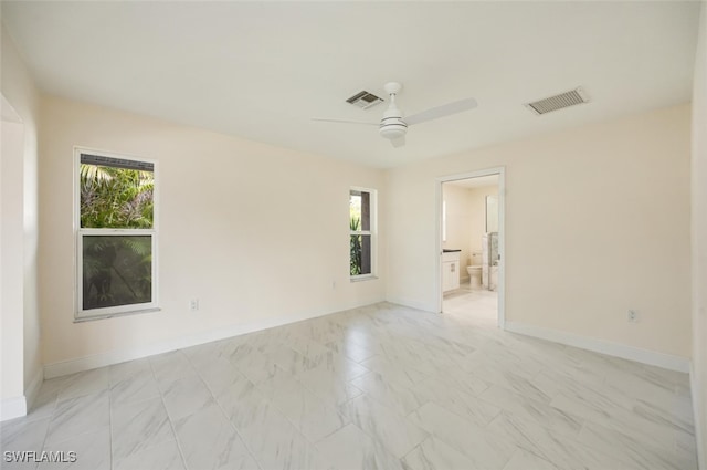 2232 Longboat Dr, Naples, FL 34104 - unfurnished room featuring a ceiling fan, light marble finish flooring, and baseboards