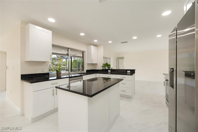 2232 Longboat Dr, Naples, FL 34104 - kitchen with stainless steel refrigerator with ice dispenser, a peninsula, recessed lighting, white cabinetry, and baseboards