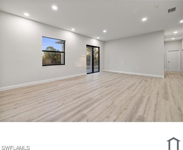 spare room featuring light wood finished floors, visible vents, baseboards, and recessed lighting