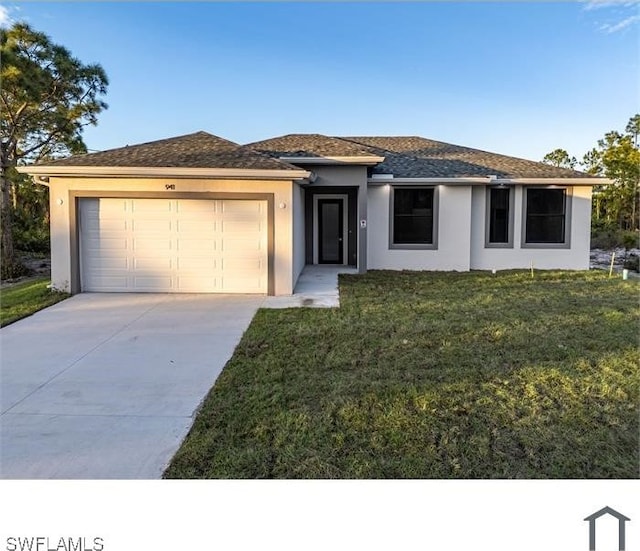 prairie-style home featuring a front lawn, driveway, stucco siding, and an attached garage