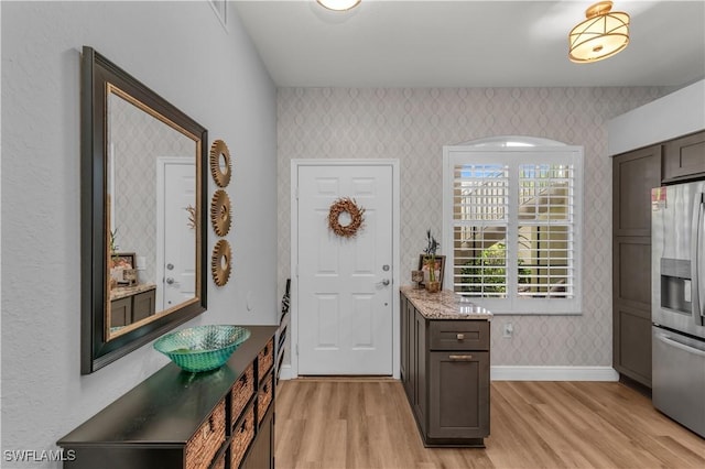 350 Newport Dr Unit 1902, Naples, FL 34114 - foyer entrance with wallpapered walls, light wood-style floors, and baseboards