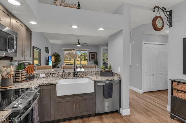 350 Newport Dr Unit 1902, Naples, FL 34114 - kitchen with stainless steel appliances, a sink, ceiling fan, light wood finished floors, and light stone countertops