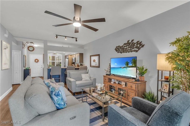 350 Newport Dr Unit 1902, Naples, FL 34114 - living area with a ceiling fan, wood finished floors, rail lighting, and baseboards