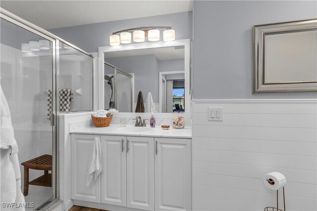 350 Newport Dr Unit 1902, Naples, FL 34114 - bathroom featuring a shower stall, vanity, and wainscoting