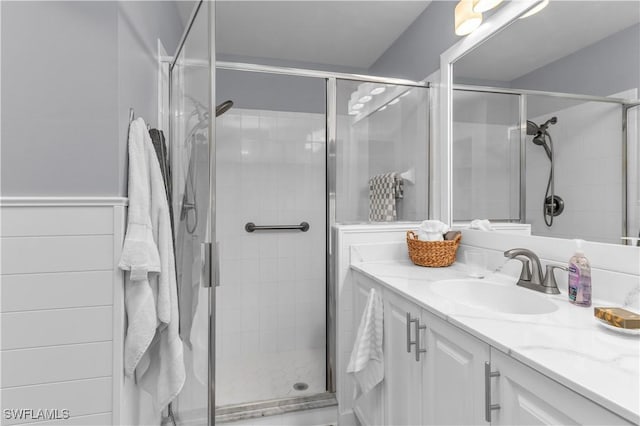350 Newport Dr Unit 1902, Naples, FL 34114 - bathroom featuring a stall shower, vanity, and wainscoting