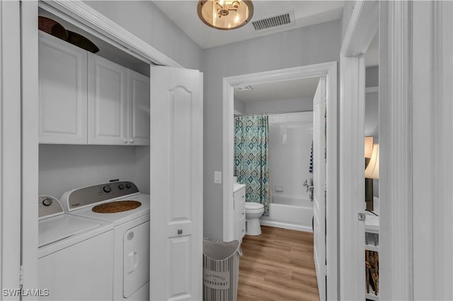 350 Newport Dr Unit 1902, Naples, FL 34114 - washroom featuring cabinet space, washing machine and clothes dryer, and light wood-type flooring