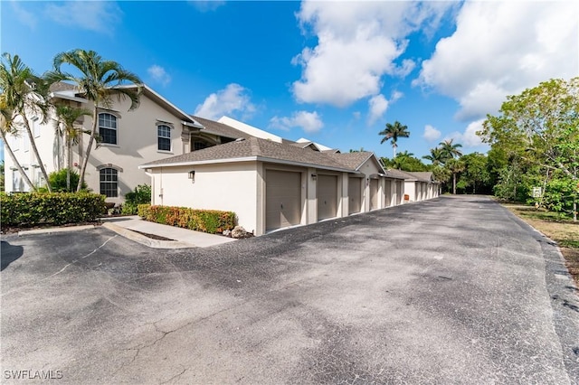 350 Newport Dr Unit 1902, Naples, FL 34114 - view of side of home featuring community garages and stucco siding