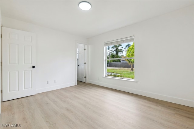 unfurnished room featuring wood finished floors and baseboards