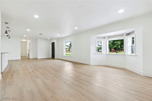 unfurnished living room featuring visible vents, light wood-style flooring, baseboards, and recessed lighting
