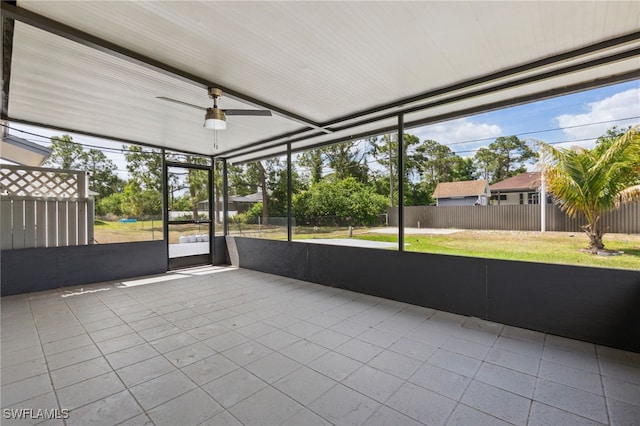 unfurnished sunroom featuring a ceiling fan