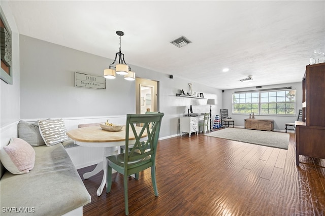 217 W Del Monte Ave, Clewiston, FL 33440 - dining area with a chandelier, baseboards, dark wood-type flooring, and visible vents