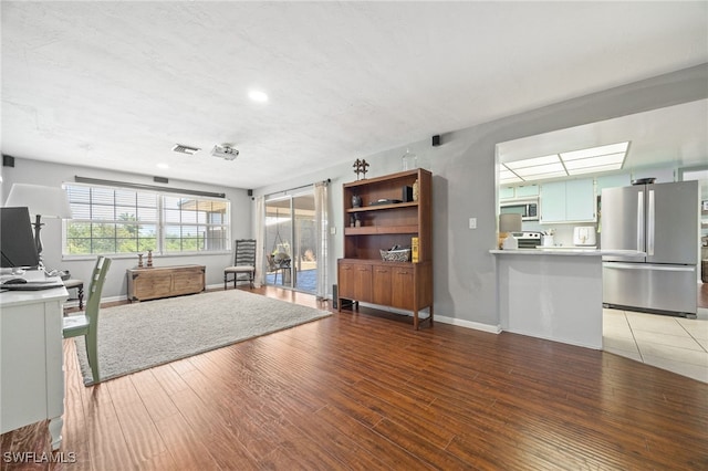 217 W Del Monte Ave, Clewiston, FL 33440 - unfurnished living room with baseboards, recessed lighting, and light wood-type flooring