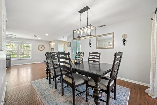 217 W Del Monte Ave, Clewiston, FL 33440 - dining area featuring baseboards, a notable chandelier, visible vents, and wood finished floors