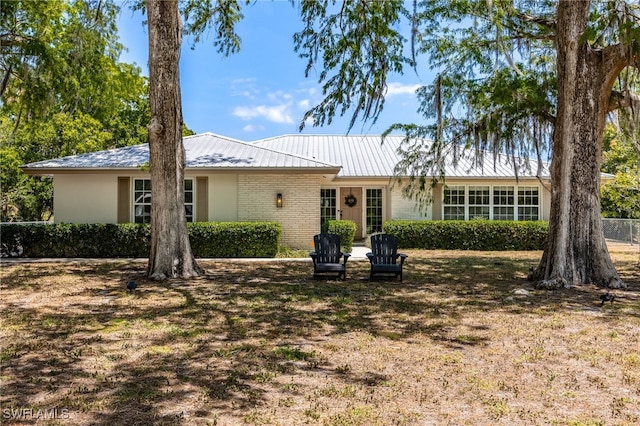 217 W Del Monte Ave, Clewiston, FL 33440 - view of front of property with metal roof and brick siding