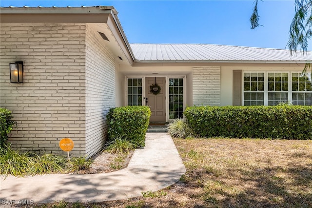 217 W Del Monte Ave, Clewiston, FL 33440 - view of exterior entry with metal roof and brick siding