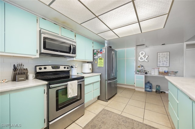 217 W Del Monte Ave, Clewiston, FL 33440 - kitchen with light tile patterned floors, backsplash, light countertops, and stainless steel appliances