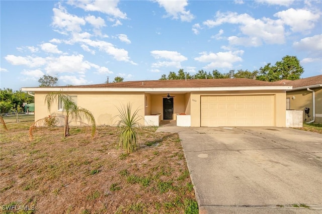 2414 Parkview Dr, Fort Myers, FL 33905 - ranch-style home with an attached garage, stucco siding, and driveway