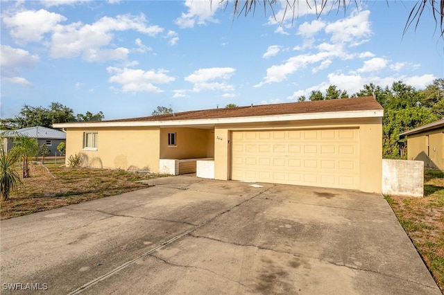 2414 Parkview Dr, Fort Myers, FL 33905 - view of front of property with stucco siding, driveway, and a garage
