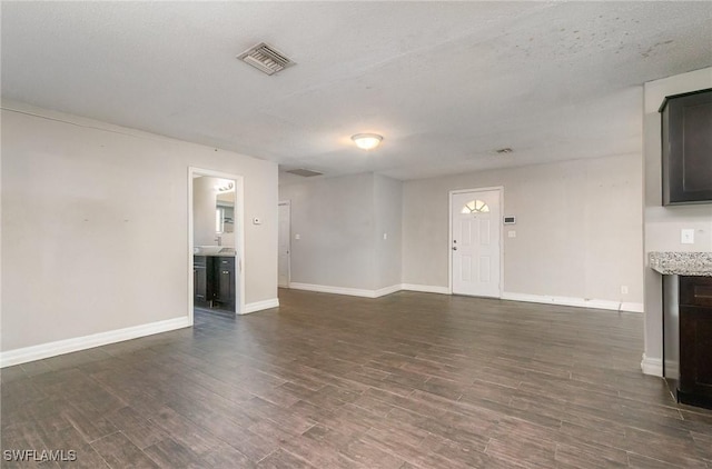2414 Parkview Dr, Fort Myers, FL 33905 - unfurnished living room with dark wood-type flooring and baseboards