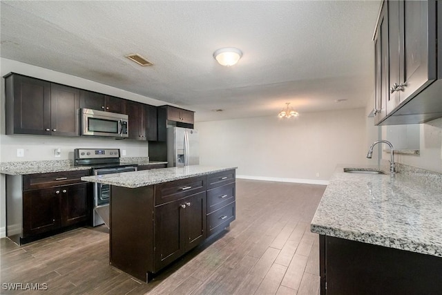 2414 Parkview Dr, Fort Myers, FL 33905 - kitchen with stainless steel appliances, a sink, a center island, and dark wood-style flooring