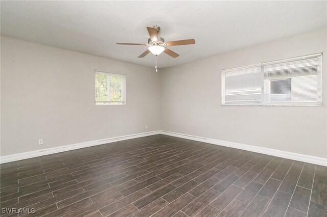 2414 Parkview Dr, Fort Myers, FL 33905 - spare room featuring ceiling fan, baseboards, and dark wood-style flooring