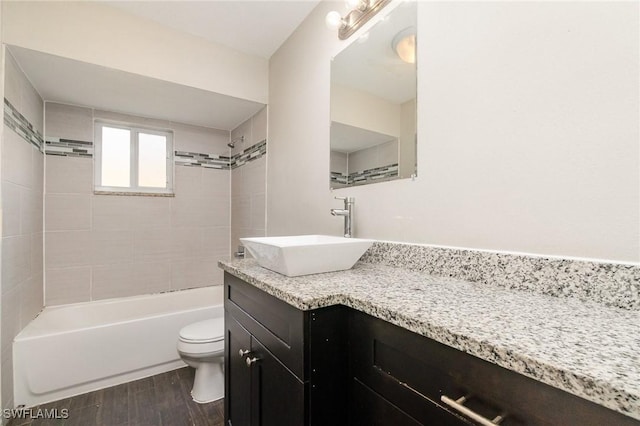 2414 Parkview Dr, Fort Myers, FL 33905 - full bathroom with toilet, wood finished floors, vanity, and bathing tub / shower combination