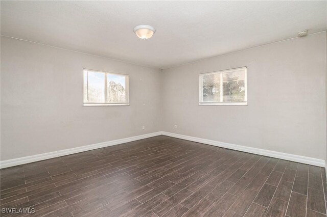 2414 Parkview Dr, Fort Myers, FL 33905 - spare room with healthy amount of natural light, baseboards, and dark wood finished floors