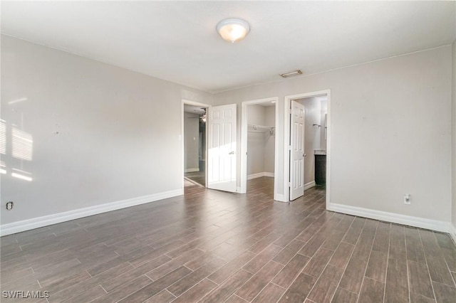2414 Parkview Dr, Fort Myers, FL 33905 - unfurnished bedroom with baseboards, dark wood finished floors, a closet, and a spacious closet