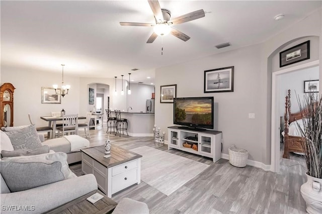 17084 Acapulco Rd Unit 222, Punta Gorda, FL 33955 - living room featuring arched walkways, baseboards, ceiling fan, and light wood-type flooring