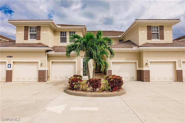17084 Acapulco Rd Unit 222, Punta Gorda, FL 33955 - view of front of house with a garage, driveway, and a tiled roof