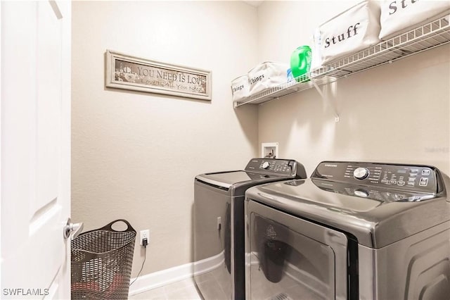 17084 Acapulco Rd Unit 222, Punta Gorda, FL 33955 - clothes washing area with washing machine and dryer, baseboards, and tile patterned flooring