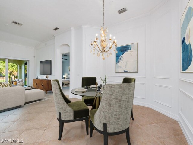 1264 Rialto Way Unit 201, Naples, FL 34114 - dining space featuring light tile patterned floors, a notable chandelier, visible vents, a decorative wall, and ornamental molding