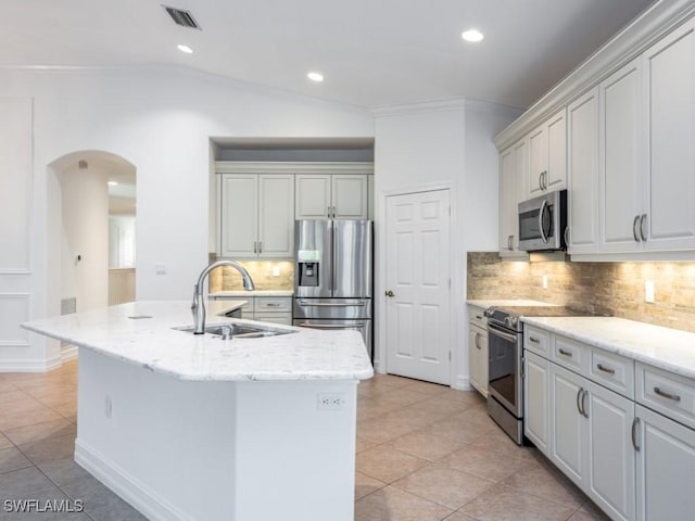 1264 Rialto Way Unit 201, Naples, FL 34114 - kitchen with a sink, stainless steel appliances, visible vents, arched walkways, and tasteful backsplash