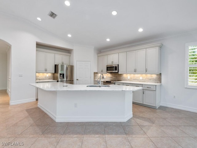 1264 Rialto Way Unit 201, Naples, FL 34114 - kitchen with visible vents, a sink, crown molding, arched walkways, and stainless steel appliances