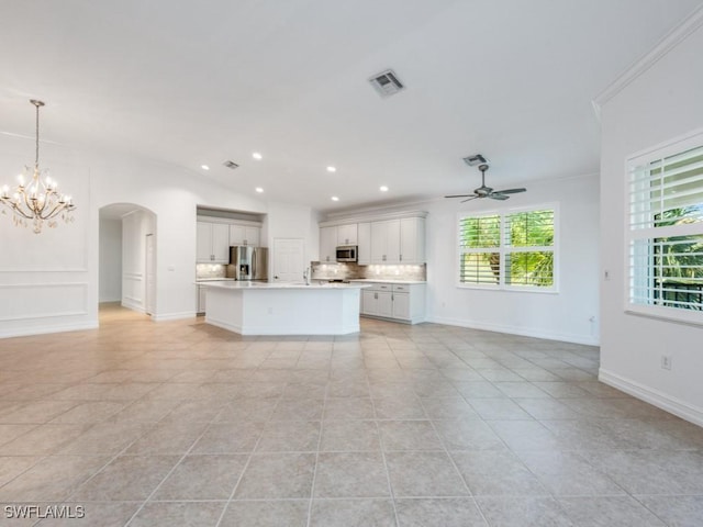 1264 Rialto Way Unit 201, Naples, FL 34114 - unfurnished living room featuring light tile patterned floors, ceiling fan with notable chandelier, visible vents, arched walkways, and recessed lighting