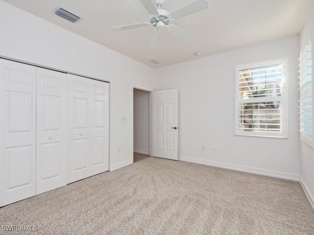 1264 Rialto Way Unit 201, Naples, FL 34114 - unfurnished bedroom with a closet, visible vents, baseboards, and carpet floors