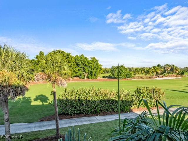 1264 Rialto Way Unit 201, Naples, FL 34114 - view of community featuring view of golf course and a lawn