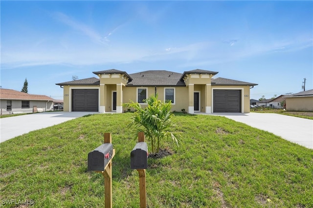 prairie-style home with driveway, a garage, and stucco siding