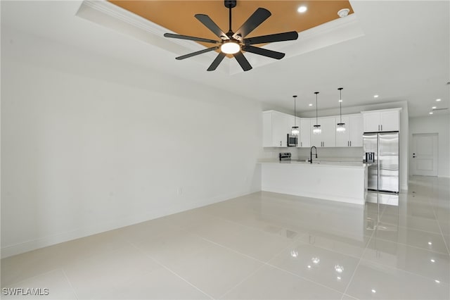 unfurnished living room with a tray ceiling, a sink, recessed lighting, light tile patterned flooring, and ornamental molding
