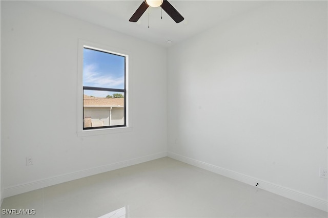 unfurnished room featuring a ceiling fan and baseboards