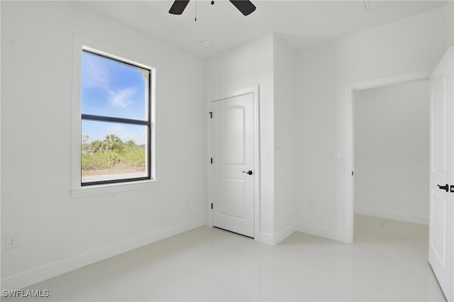 unfurnished bedroom with baseboards, ceiling fan, and light tile patterned flooring