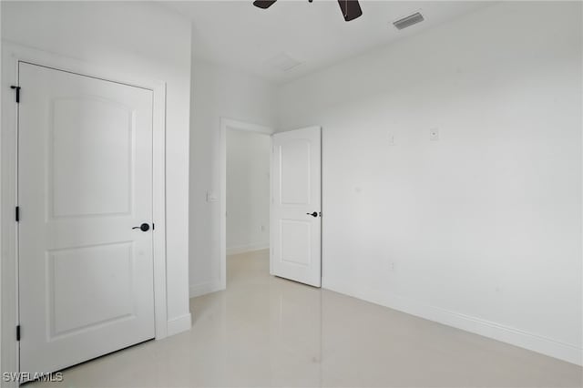 unfurnished bedroom with baseboards, light tile patterned floors, and a ceiling fan