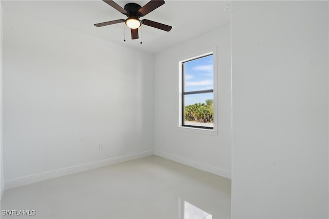empty room featuring baseboards and ceiling fan