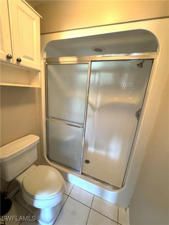 388 Belina Dr Unit 6, Naples, FL 34104 - full bathroom with toilet, a shower stall, and tile patterned floors