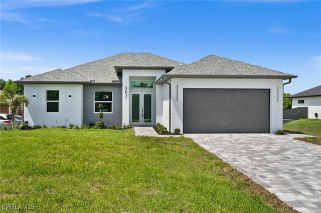 3631 68th Ave NE, Naples, FL 34120 - prairie-style house with french doors, a garage, stucco siding, a shingled roof, and a front yard