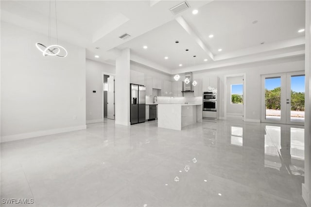 3631 68th Ave NE, Naples, FL 34120 - unfurnished living room with visible vents, baseboards, a raised ceiling, and recessed lighting