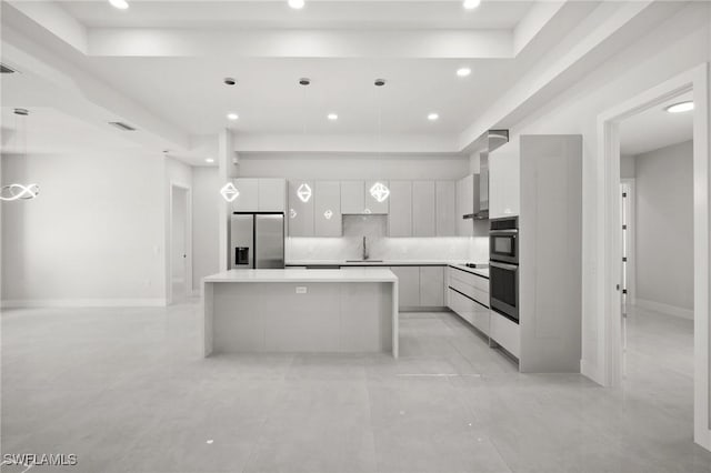 3631 68th Ave NE, Naples, FL 34120 - kitchen with a center island, white cabinets, modern cabinets, a raised ceiling, and appliances with stainless steel finishes