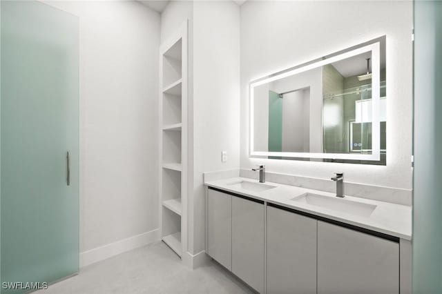 3631 68th Ave NE, Naples, FL 34120 - full bath with a sink, double vanity, walk in shower, and baseboards