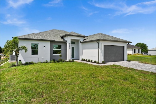 3631 68th Ave NE, Naples, FL 34120 - prairie-style house featuring a front yard, a garage, stucco siding, and driveway